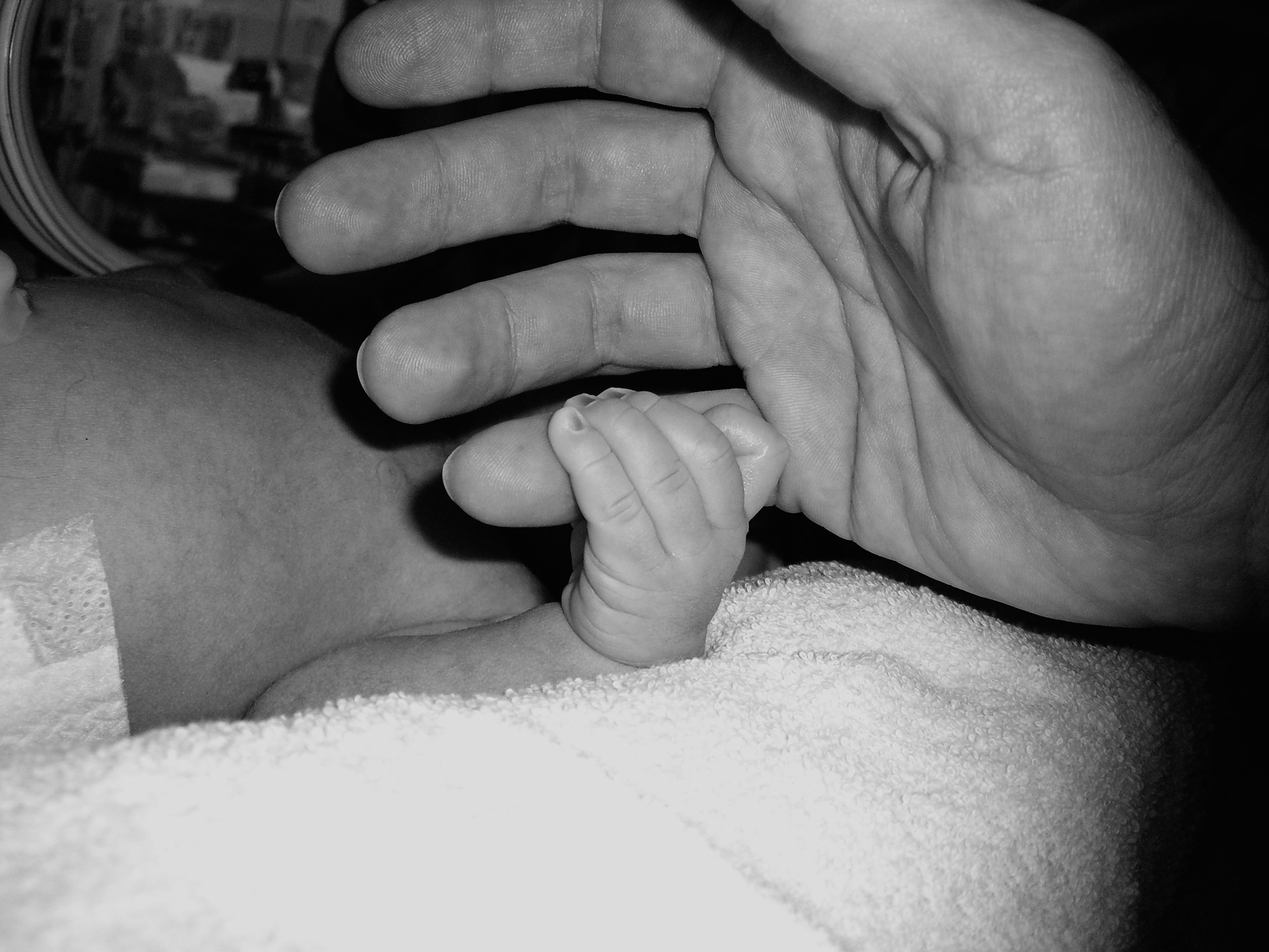 His hand holding onto mine in the nursery.